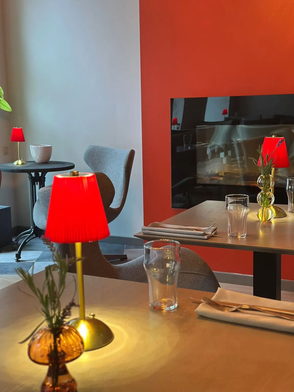 A table at FLO laid for dinner, garnet lamps lit