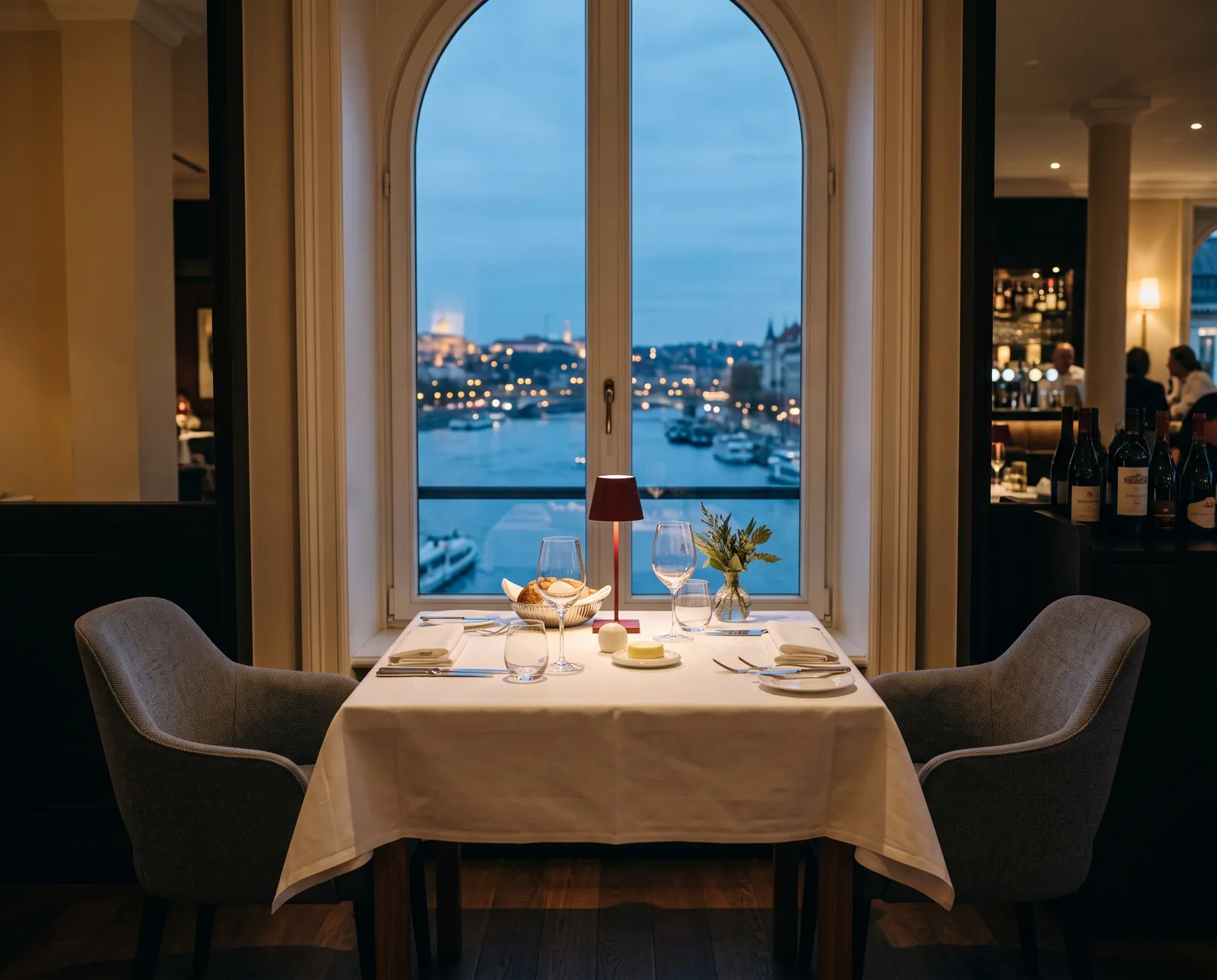 A window table for two at blue hour, set and waiting